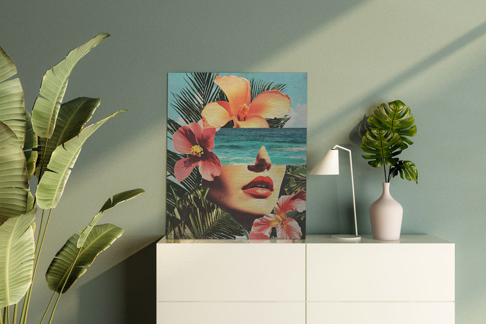 Tropical face artwork with flowers and ocean – displayed in light modern interior
