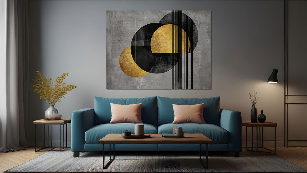 Black and gold painting hanging above navy blue couch in modern home