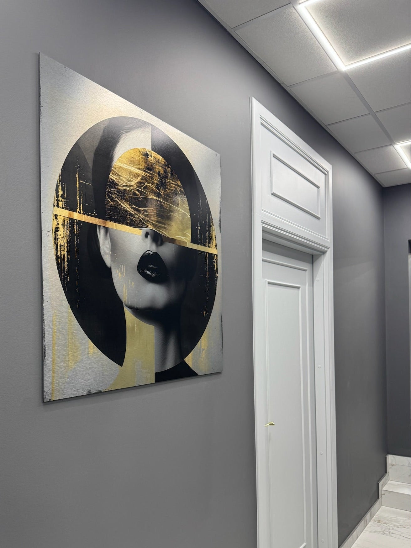 Artistic portrait of a woman on a gray wall in an indoor setting