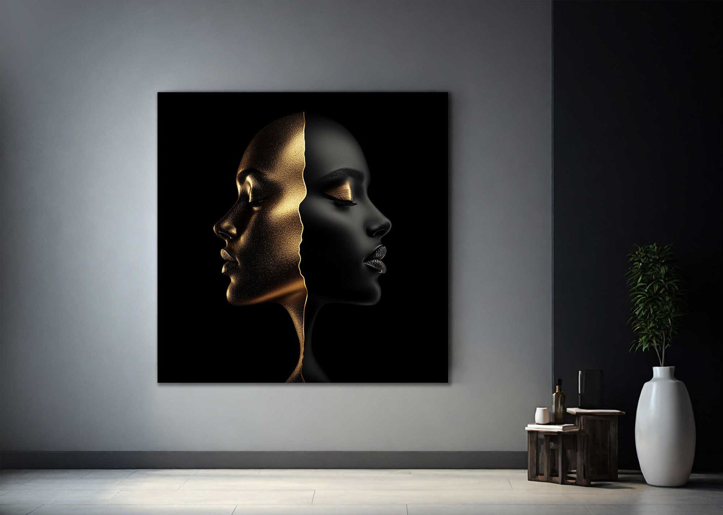 Minimal black and gold face artwork on metal against grey wall