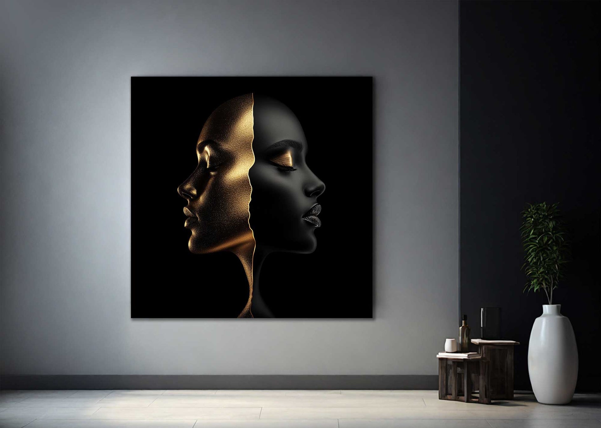 Minimal black and gold face artwork on metal against grey wall