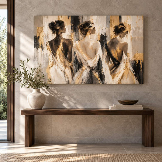Canvas print of three women in gold-accent dresses displayed above a console table in a modern entryway