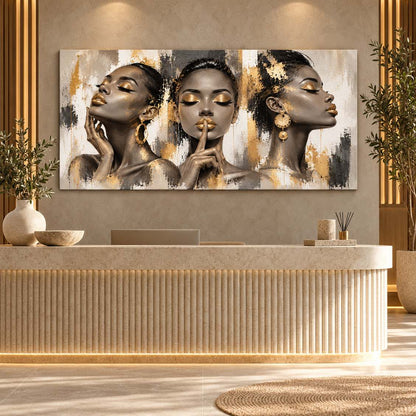 Gold-accent three-women portrait canvas print displayed above a stone reception desk in a modern lobby