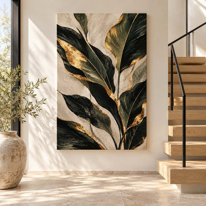 Canvas print of gold-accent green leaves displayed in a modern entryway beside a staircase
