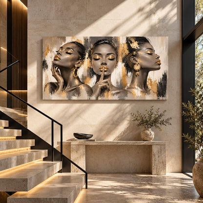 Gold-accent three-women portrait canvas print displayed above a console table near a staircase entryway