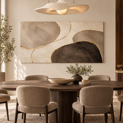 Canvas print of abstract pebble-shaped forms displayed above a dining table beneath a sculptural pendant light