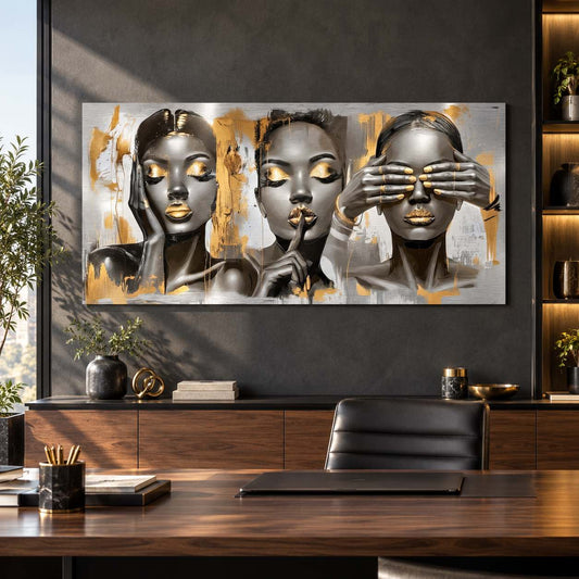 Metal print of three female portraits with gold accents displayed above a desk in a modern home office