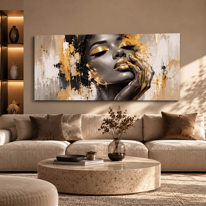 Monochrome gold-accent portrait canvas print displayed above a sofa beside a lit display shelf