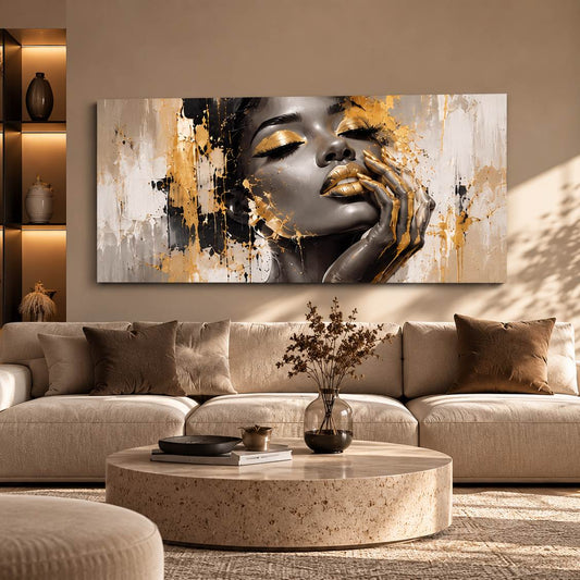 Monochrome gold-accent portrait canvas print displayed above a sofa beside a lit display shelf