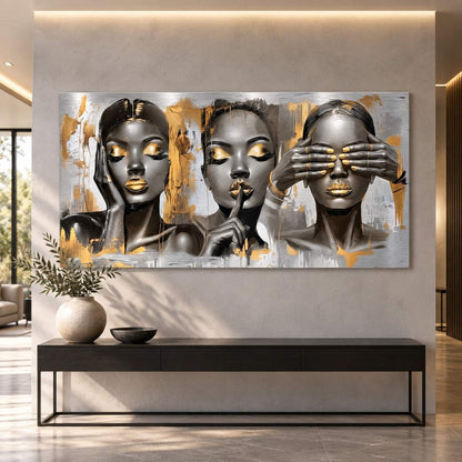 Metal print of three female portraits with gold accents displayed above a console table in a modern hallway