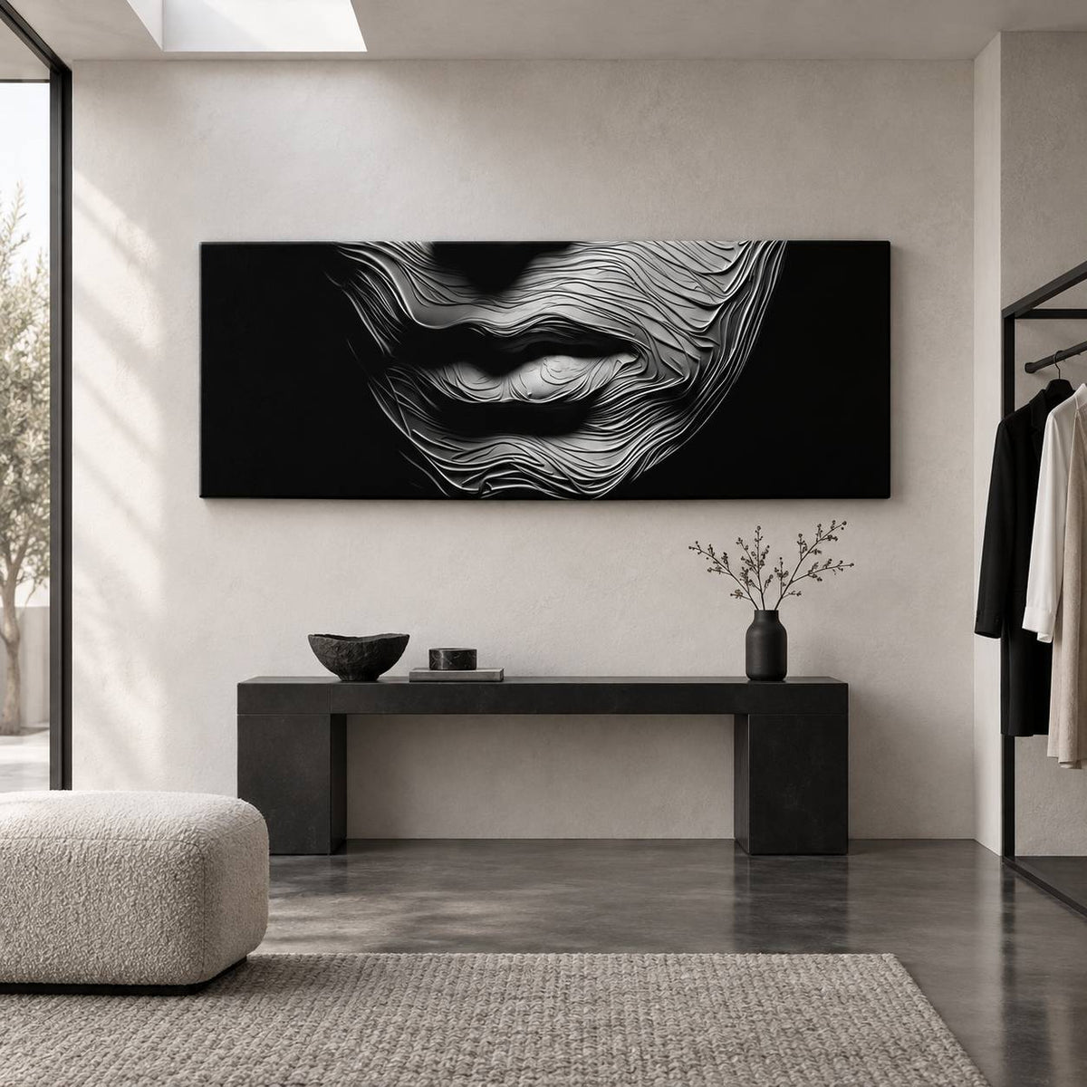 Black and white textured lips canvas print displayed above a black bench in a minimalist entryway