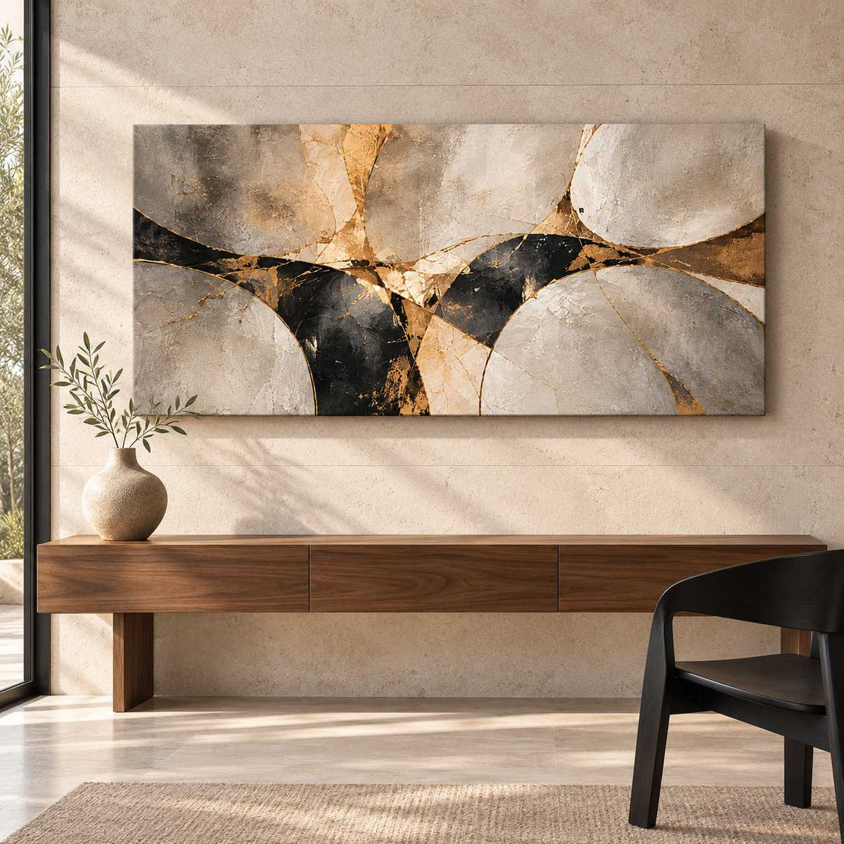 Abstract stone and gold canvas print displayed above a wooden console table with a black accent chair