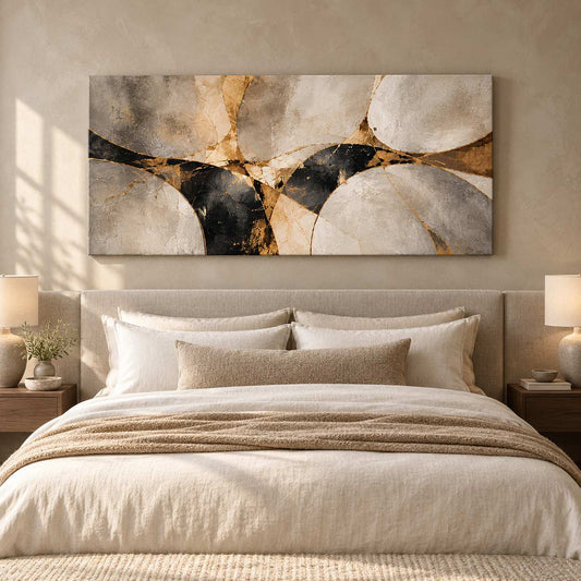 Abstract stone and gold canvas print displayed above a bed in a warm neutral bedroom