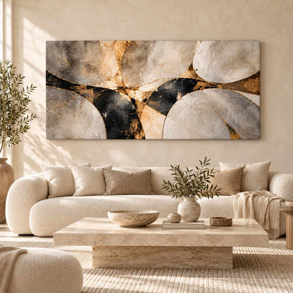 Abstract stone and gold canvas print displayed above a cream sofa in a bright living room