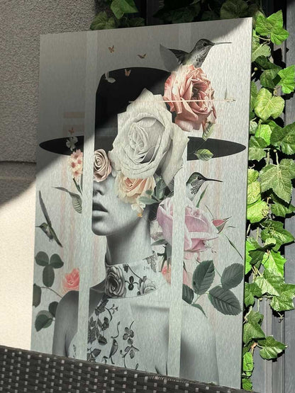 Vertical female collage artwork with flowers, displayed on a green living wall